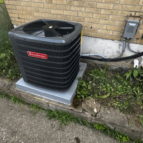 HVAC technician performing spring AC maintenance on outdoor unit at Ohio home