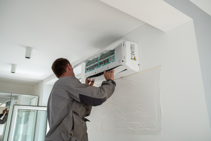 Technician installing ductless mini-split indoor unit in Cincinnati and Dayton, Ohio