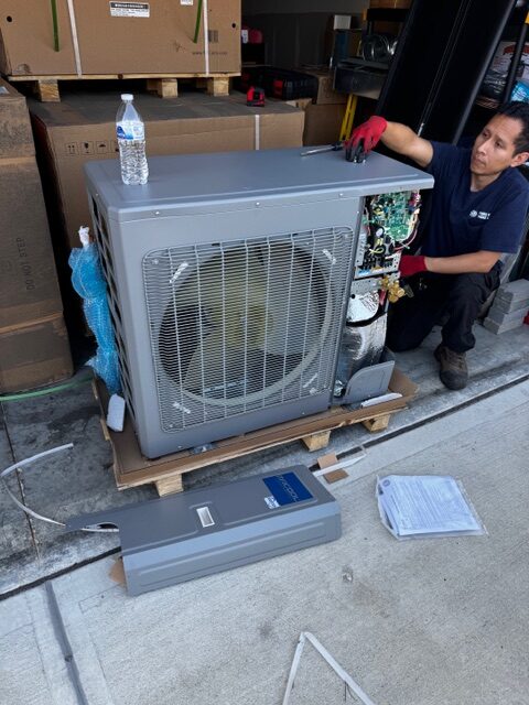 More Heat More Cool technician performing AC maintenance service in an Ohio home