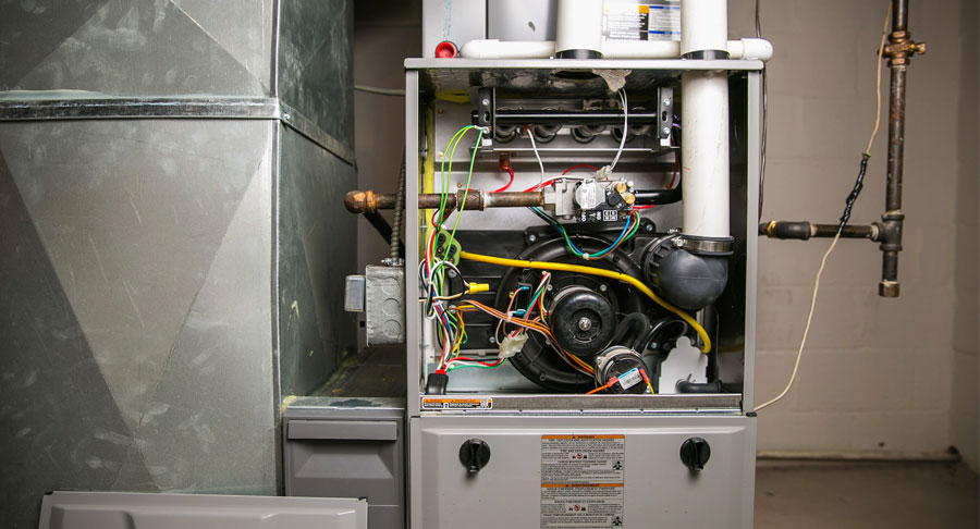 Professional technician repairing a gas furnace in an Ohio home
