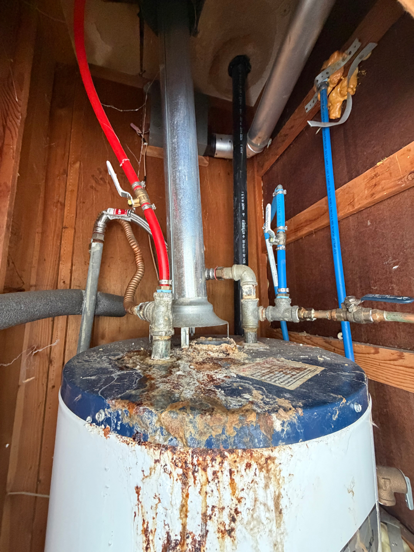 Severely corroded and rusty water heater that needs immediate replacement