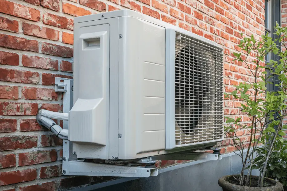 Heat pump installed beside house for energy-efficient heating and lower utility bills