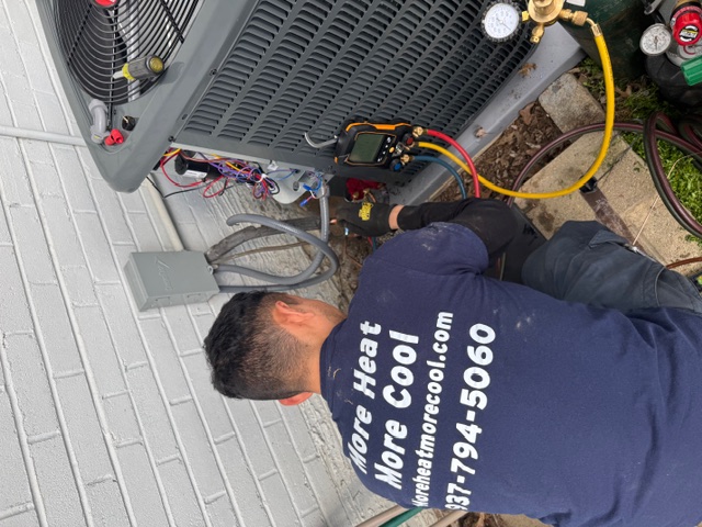 HVAC technicians installing ductless system in a garage