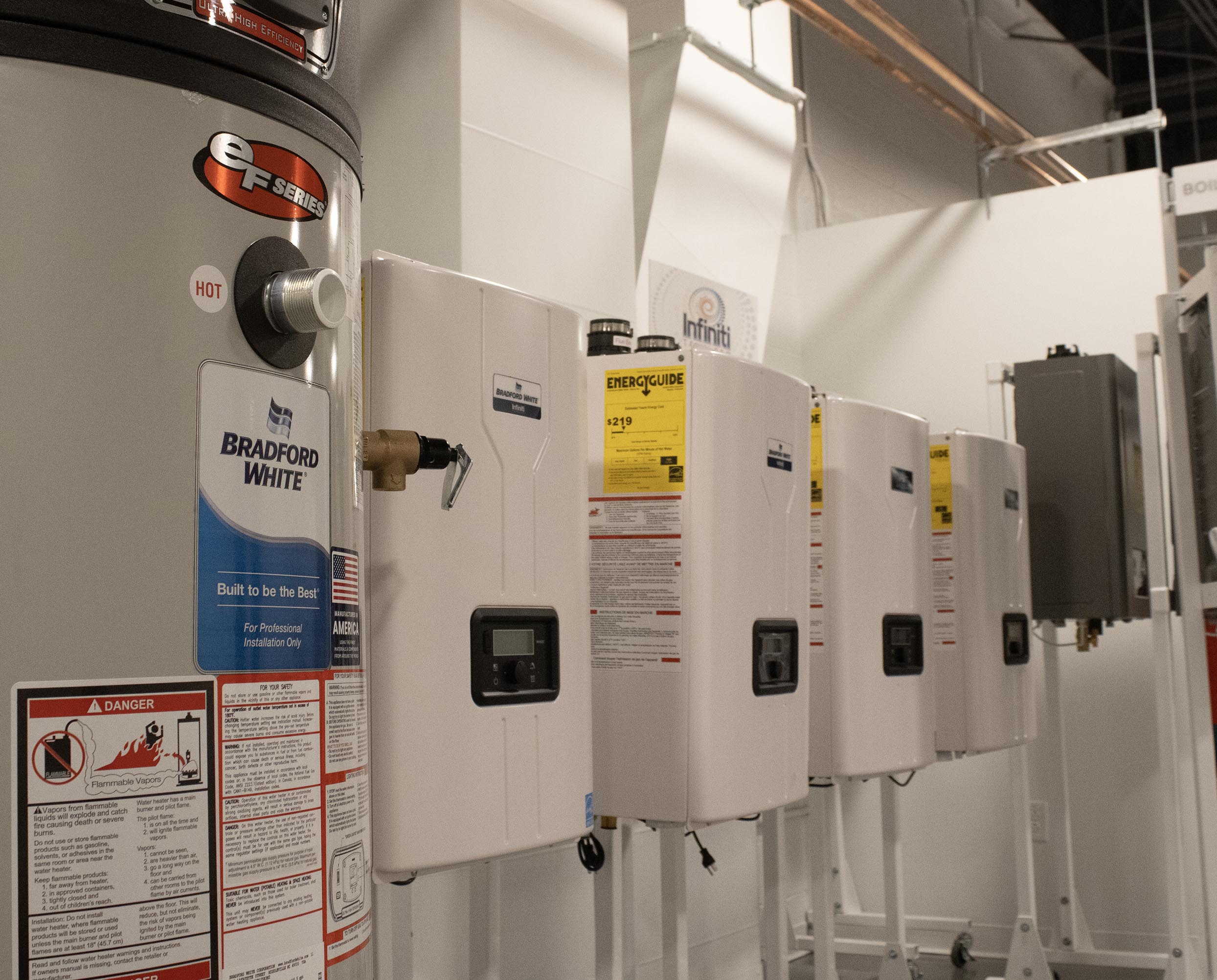 Showroom displaying Bradford White tank and Infiniti tankless water heater models