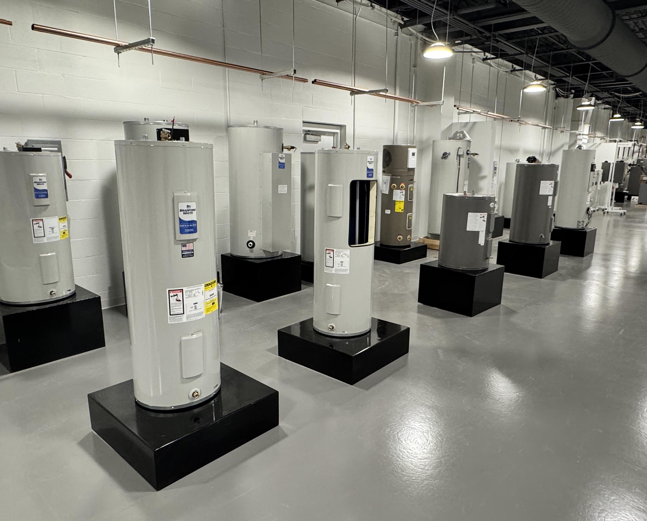Water heater warehouse displaying a wide selection of tank water heaters available for installation