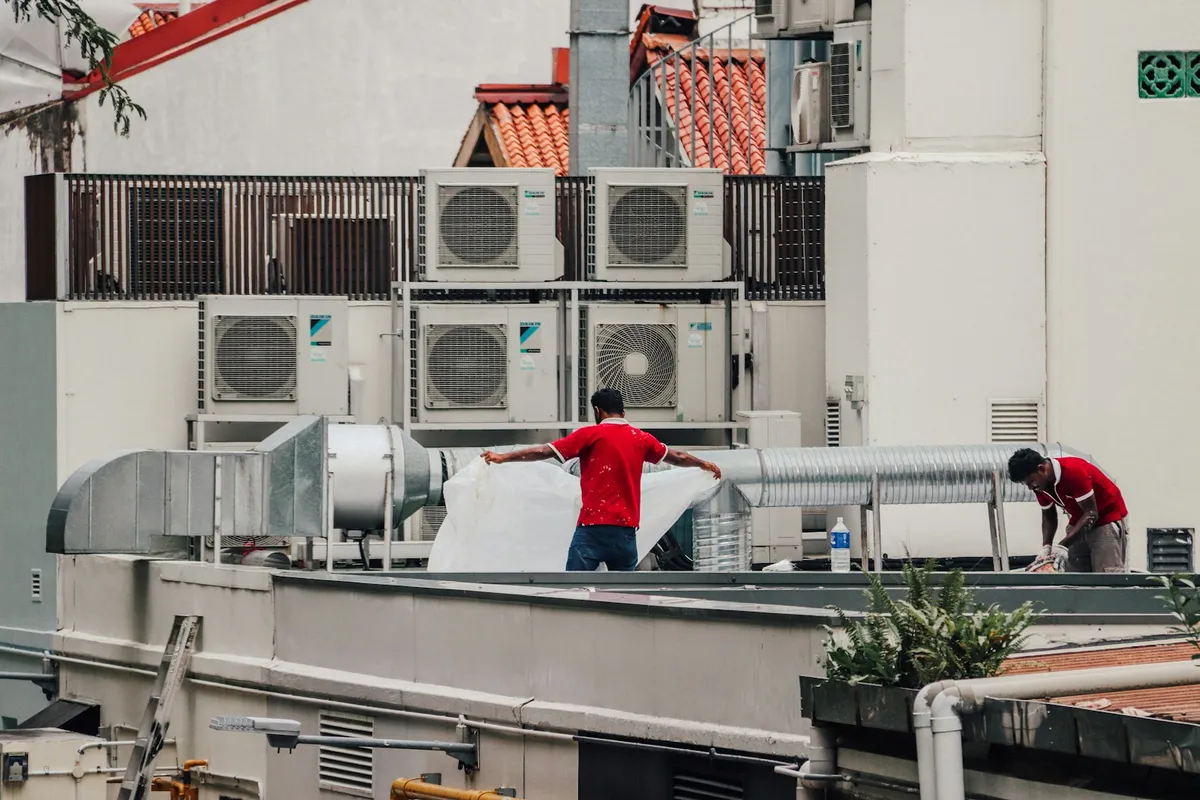 HVAC technicians performing scheduled maintenance service on HVAC equipment