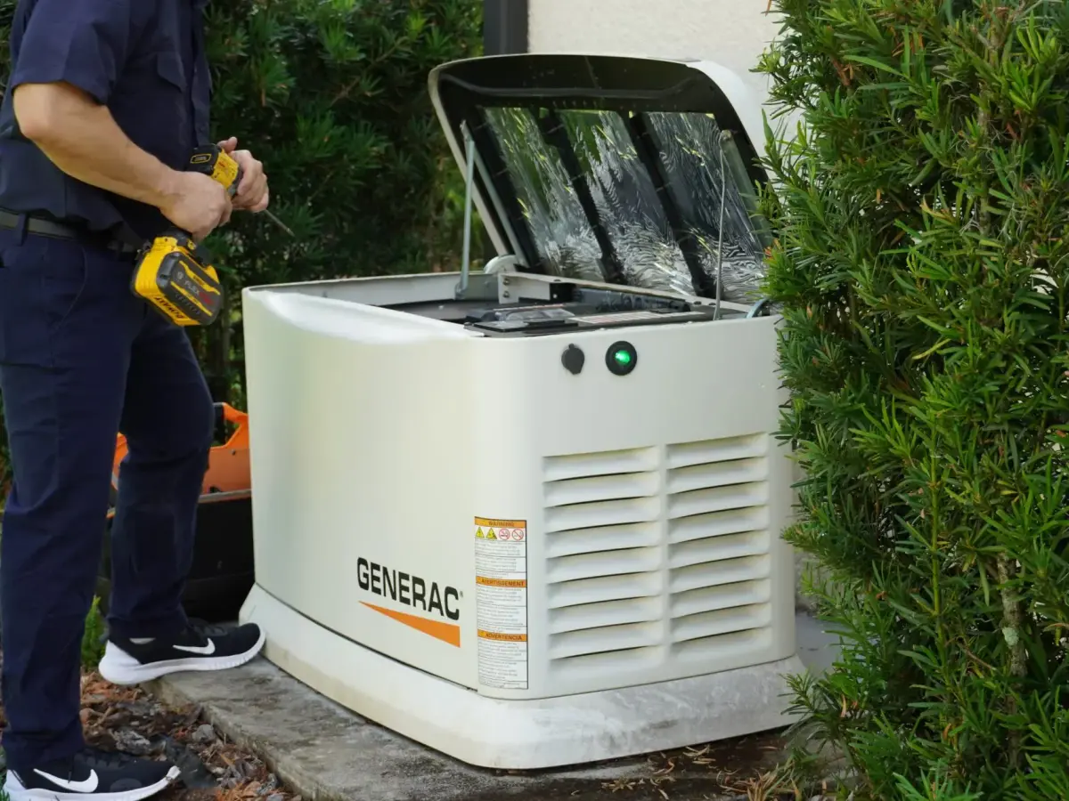 Technician servicing a Generac home standby generator
