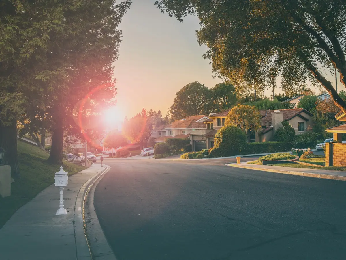 Golden-hour light over a postwar suburban street like Kettering’s