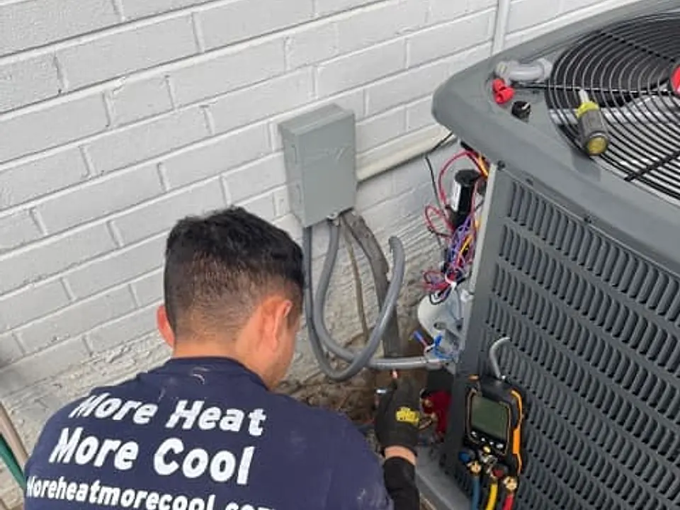 More Heat More Cool technician checking refrigerant pressures on an air conditioner at a Southwest Ohio home