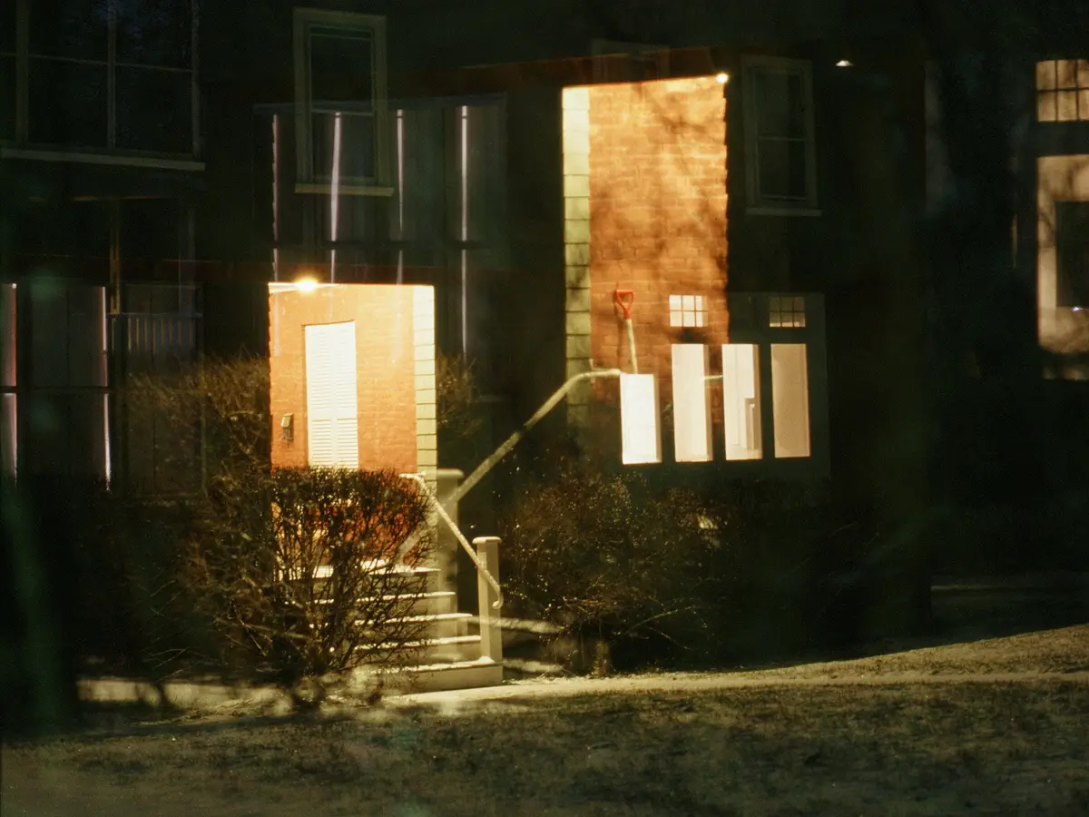 Warm-lit home on a dark night — the comfort 24/7 emergency service protects
